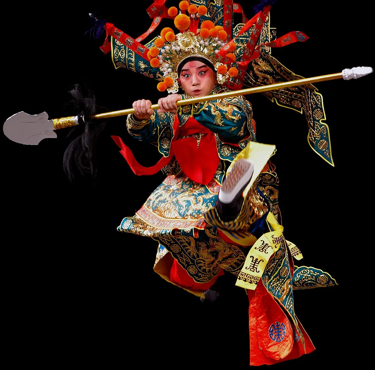 A costumed Chinese opera performer in elaborate make-up and headdress