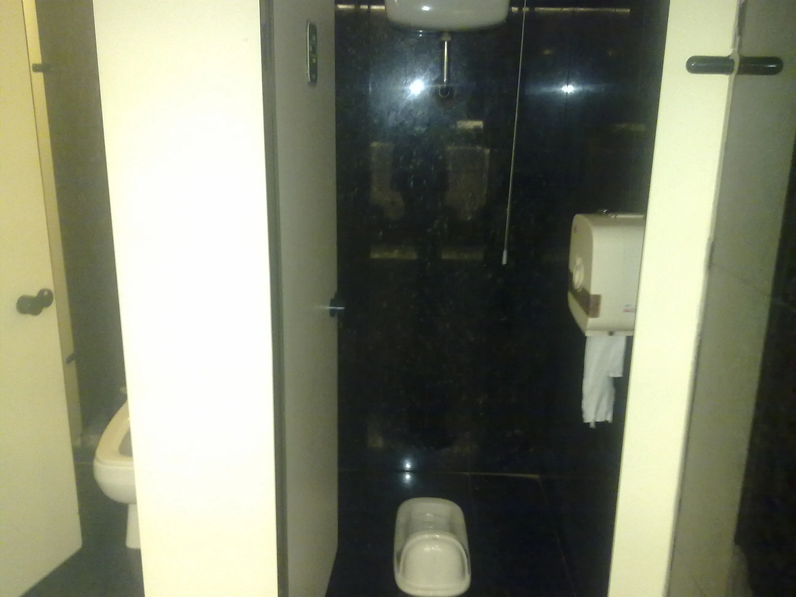 A floor-level squat toilet in a public restroom in Beijing, China