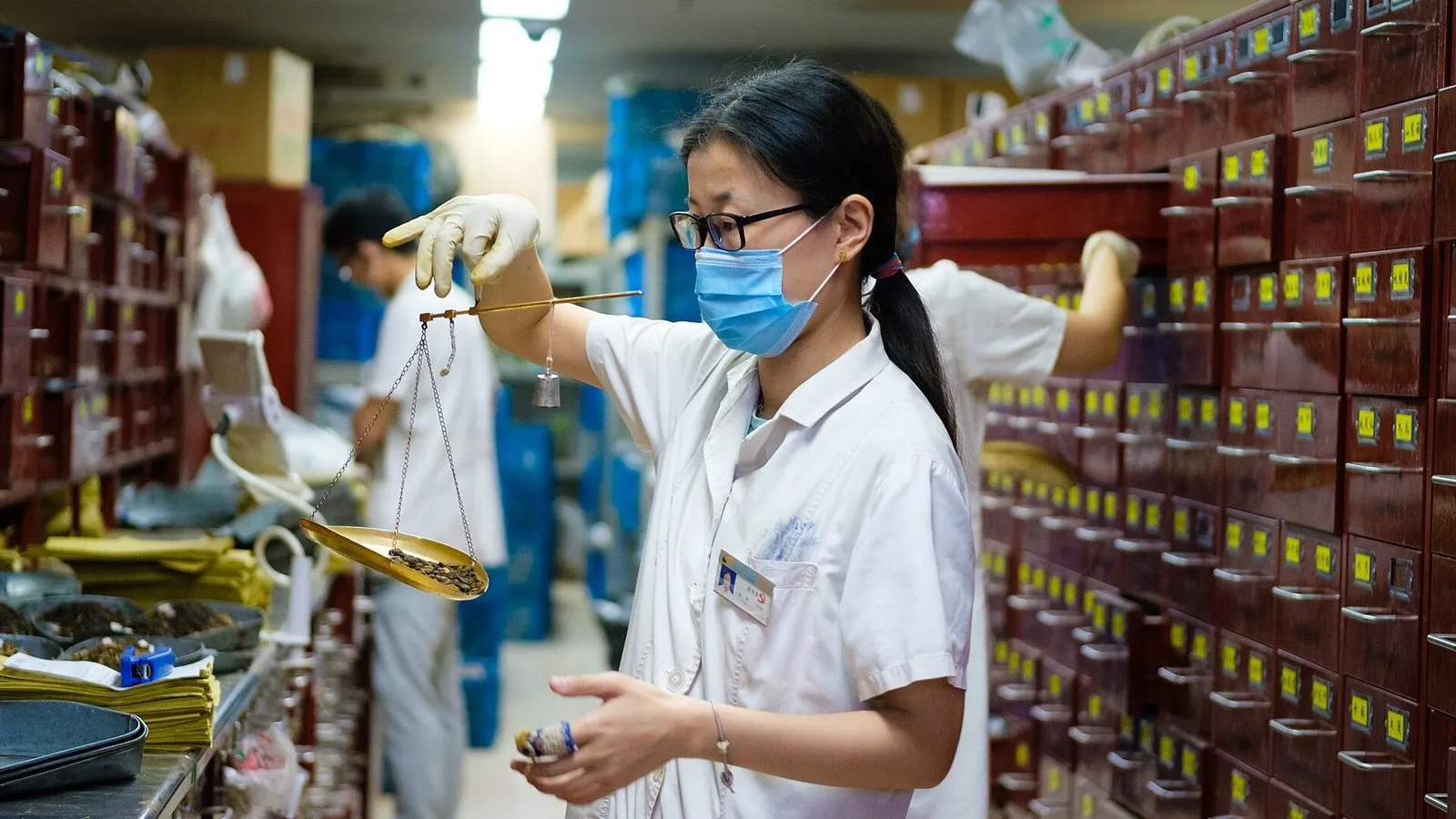 A doctor weighing herbs at a traditional Chinese medicine hospital in Nanjing